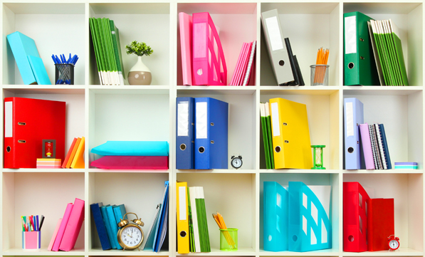 Colorful folders organized on white shelves
